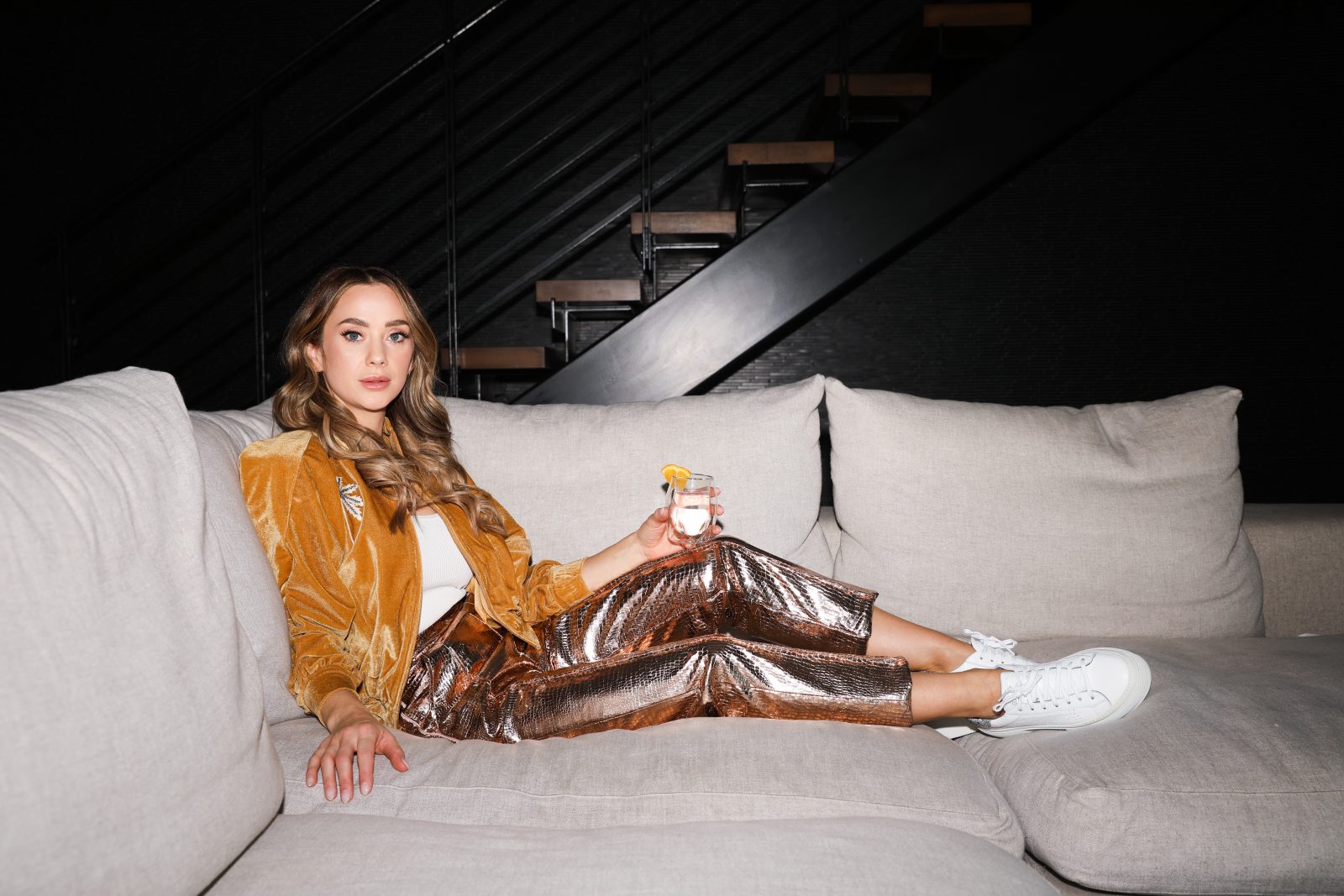 Celine on a couch with velvet yellow jacket