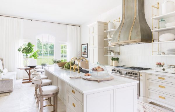 White kitchen space with neutral accent tones and gold metal elements