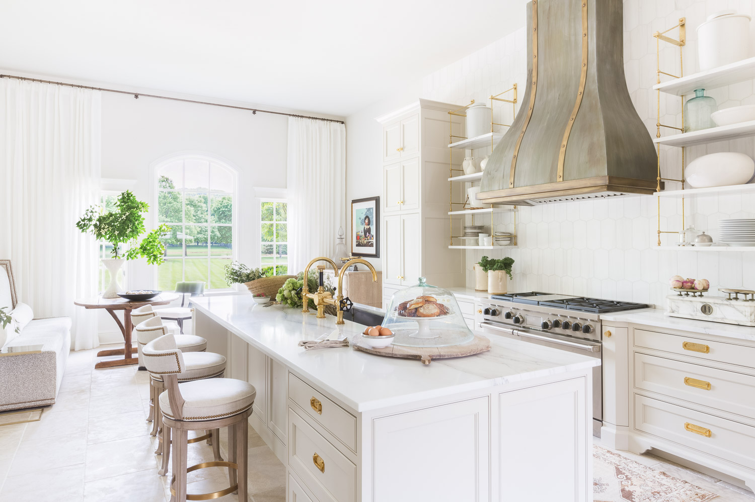 White kitchen space with neutral accent tones and gold metal elements